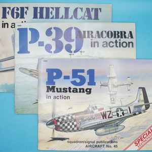 May include: Three vintage books about military aircraft. The covers feature illustrations of a P-39 Airacobra, a P-51 Mustang, and a F6F Hellcat. The books are titled "P-39 Airacobra in action", "P-51 Mustang in action", and "F6F Hellcat in a..."
