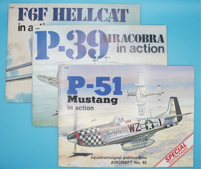 May include: Three vintage books about military aircraft. The covers feature illustrations of a P-39 Airacobra, a P-51 Mustang, and a F6F Hellcat. The books are titled "P-39 Airacobra in action", "P-51 Mustang in action", and "F6F Hellcat in a..."