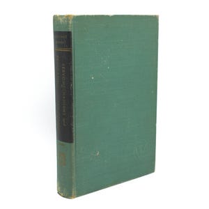 May include: A vintage hardcover book with a teal cover and a black spine. The spine features the title "SERVOMECHANISMS and" in white text. The book's cover shows signs of wear, suggesting its age. The book is set against a white background.