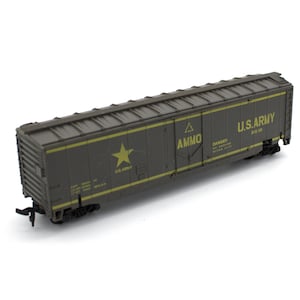 May include: A model train boxcar in olive drab green with yellow lettering and graphics. The side features a yellow star, the text U.S. ARMY, the word AMMO, and a danger warning. The car has a corrugated roof, sliding doors, and black wheels.