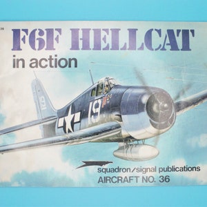May include: A vintage book cover featuring a blue and white F6F Hellcat fighter plane in flight. The cover is titled "F6F Hellcat in action" and includes the text "Squadron/Signal Publications Aircraft No. 36".