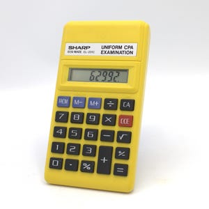 May include: A yellow Sharp ELSI MATE EL-231C calculator with black buttons and a digital display showing "62992.". The calculator has the text "UNIFORM CPA EXAMINATION" on the top. It is a handheld device.