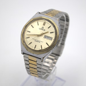 Vintage Lorus Men's wristwatch silver gold tone stainless analog dial weekday calendar date adjustable steel band water resyant quartz Japan