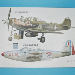 May include: A vintage illustration of two military aircraft. The top aircraft is a green and brown P-39F fighter plane with the words "Air-A-cutie" painted on the side. The bottom aircraft is a silver P-63C fighter plane with the words "5TB" painted on the side. Both aircraft have French markings.