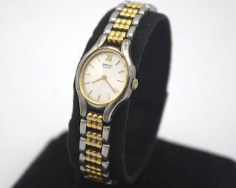 Vintage Seiko woman's wristwatch analog dial polished silver chrome and gold tone quartz watch Japan 1980s