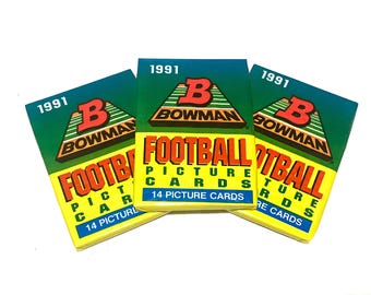May include: Three packs of 1991 Bowman Football Picture Cards. Each pack has a green, yellow, and red design with the Bowman logo and the text "1991 Bowman Football Picture Cards".
