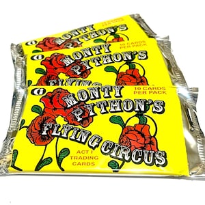 May include: A white ceramic mug with a black handle and the text "But First, Coffee" in a bold, black font. The mug is sitting on a wooden surface. The mug is 4 inches tall.