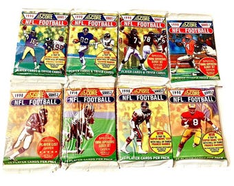 May include: A set of ten 1990 Score NFL Football trading cards. The cards feature different NFL players from the 1990 season. Each card has a different design and features a player's name, team, and position. The cards are in good condition and are a great addition to any NFL fan's collection.