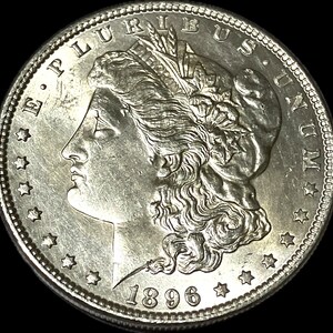 May include: A close-up of a silver coin with a profile of a woman's face, surrounded by text and stars. The coin is dated 1896. The words "E PLURIBUS UNUM" are visible.