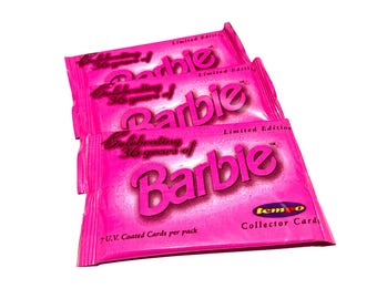 May include: Three pink Barbie collector card packs. Each pack features the Barbie logo and text celebrating 36 years of Barbie. The packs are labeled as limited edition and contain 7 U.V. coated cards.
