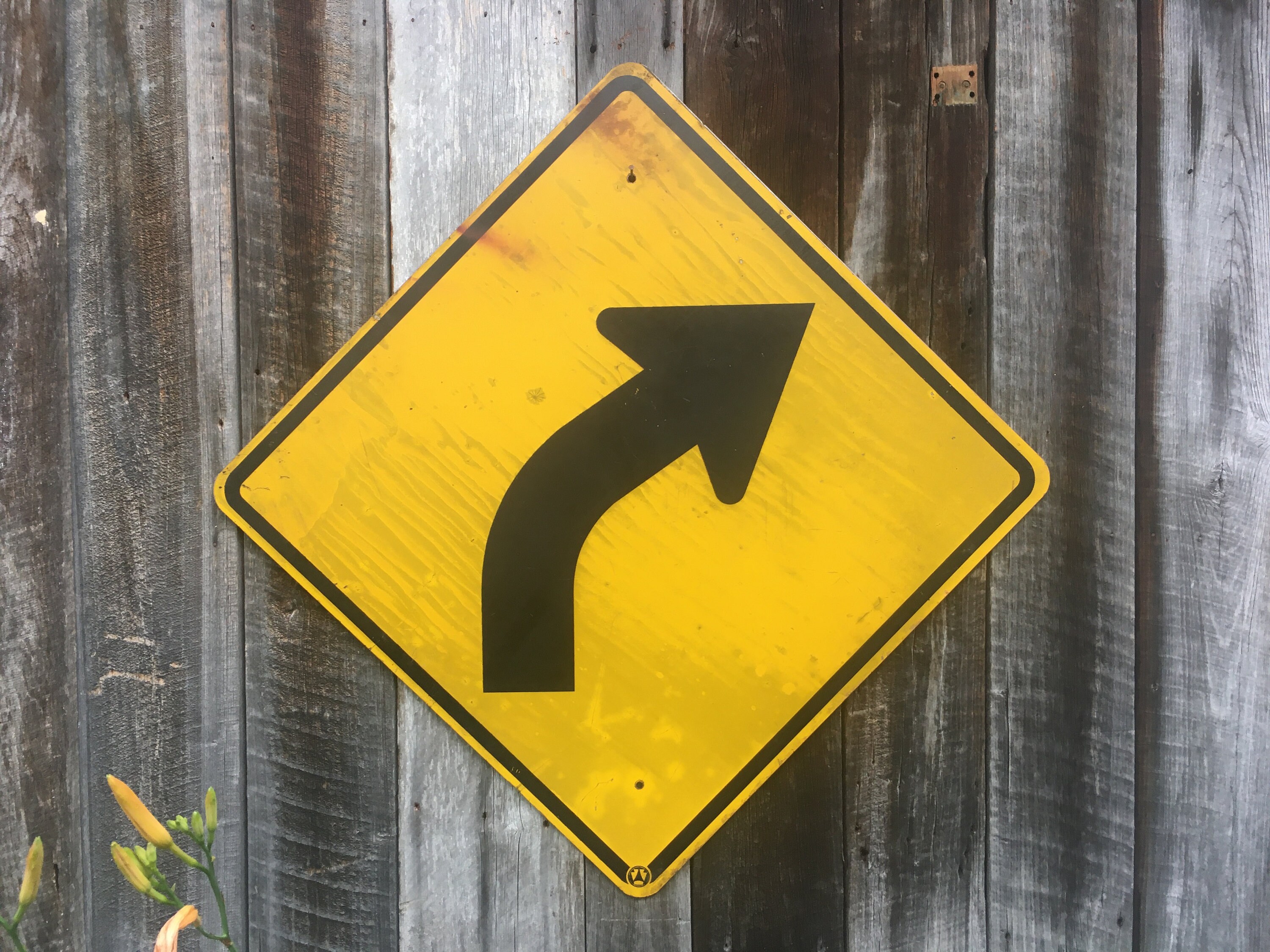 Yellow Curved Arrow Sign