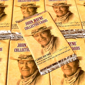 May include: A stack of sealed trading card packs featuring John Wayne. Each pack contains 6 cards and includes randomly inserted sketch art cards, costume cards, and other chase cards.