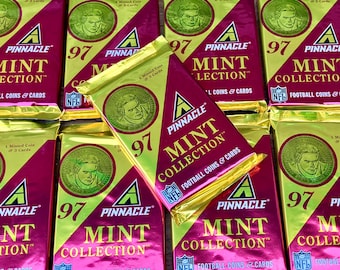 May include: A close-up of nine unopened packs of 1997 Pinnacle Mint Collection football trading cards. The packs are gold and pink with the text "Pinnacle Mint Collection" and "Football Coins & Cards".