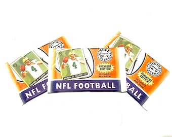 May include: Three packs of Goudey Fleer 1996-97 NFL Football trading cards. Each pack features a photo of a football player on the front and the text "Premiere Edition! 10 Cards Per Pack" on the back.