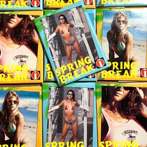 May include: A collection of vintage "Spring Break" trading cards. The cards feature images of women in swimwear, with the words "Spring Break" in yellow text. Some cards also have the word "Lifeguard" on them.