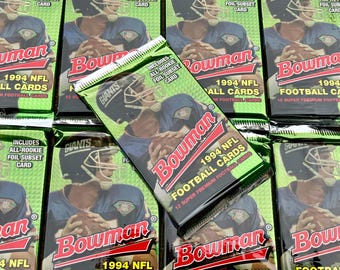 May include: A stack of Bowman 1994 NFL Football Cards trading card packs. The packs are green and feature a red and white Bowman logo with the text "1994 NFL Football Cards".
