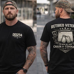 May include: Black t-shirt with the text "DD214 SUPPLY CO." on the front and "RETIRED VETERAN" with military-themed graphics on the back. The shirt features a crew neck and short sleeves. The person in the image is wearing a camouflage baseball cap.