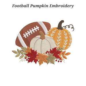 May include: An embroidery design featuring a brown football with white laces, a cream-colored pumpkin, and an orange pumpkin with white leaf patterns. The arrangement is accented with red, orange, and green autumn leaves and small red berries.