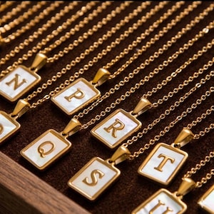 May include: A set of three ceramic nesting bowls in graduating sizes. The bowls are white with a speckled, textured finish and feature a slightly flared rim. The largest bowl measures approximately 8 inches in diameter.