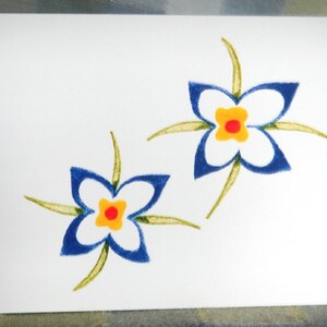 May include: Two blue flowers with yellow centers and red dots are drawn on a white card. The flowers have green stems and leaves.