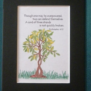 May include: A framed print with a hand-drawn illustration of a tree with green and yellow leaves. The print features a quote from Ecclesiastes 4:12: "Though one may be overpowered, two can defend themselves. A cord of three strands is not quickly broken."