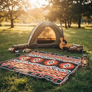 May include: An outdoor camping scene with a green tent, a guitar, and a patterned blanket. A rolled-up sleeping bag, boots, and a backpack are also visible. A lantern sits on the grass, and the scene is bathed in sunlight.