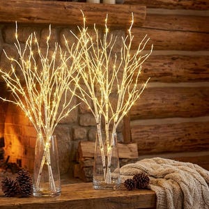 May include: A set of three ceramic mugs with a speckled, matte finish. The mugs are in shades of cream, light gray, and dark gray. Each mug has a simple, minimalist design and a rounded handle.