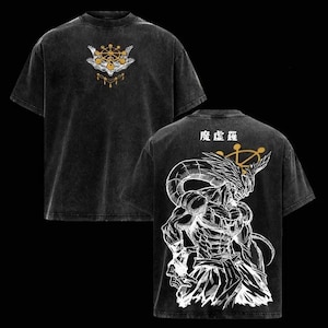 May include: Black t-shirt with a distressed wash. The front features a gold and white emblem. The back displays a detailed white illustration of a muscular figure with horns, and Japanese text. The shirt has short sleeves and a crew neck.