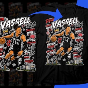 Pode incluir: Camiseta preta com um gráfico do jogador de basquete Devin Vassell com o uniforme dos Spurs. O design inclui elementos de texto como "Silent Impact", "Precision & Range" e "Shooter's Mindset."