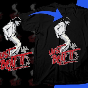 Op de afbeelding: Zwart t-shirt met een gestileerde illustratie van een persoon in een wit pak en de rode tekst "JUST BEAT IT". Het ontwerp is een eerbetoon aan een bekende muzikant.