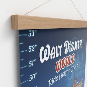 May include: A blue Walt Disney World Ride Height Chart with measurements in inches, ranging from 50" to 53". The chart is held by a wooden frame at the top. The words "Walt Disney World" are in white and red.