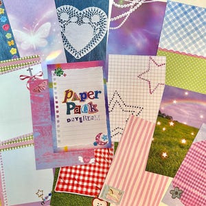 May include: A collection of decorative paper sheets with various patterns and designs. Includes denim, plaid, gingham, and striped patterns. Some sheets feature butterflies, stars, and the text "Paper Pack Daydream". The color palette includes pink, blue, and green.