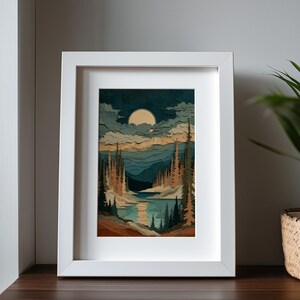 May include: A framed landscape art print featuring a serene lake scene under a full moon. The artwork showcases a forest of tall trees in shades of brown and green, with a blue lake reflecting the moon's light. The print is set in a white frame.