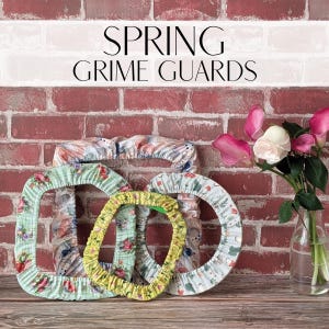 May include: Three fabric grime guards for embroidery hoops, featuring floral and mushroom patterns in green, yellow, and white. The text SPRING GRIME GUARDS is displayed above the items. The guards are elasticised and circular or square in shape.