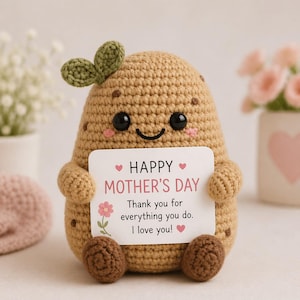 May include: A crocheted potato-shaped plush toy with a smiling face, holding a card that reads "Happy Mother's Day." The toy is tan with brown accents and green leaves. The card includes a floral design and the message "Thank you for everything you do. I love you!"