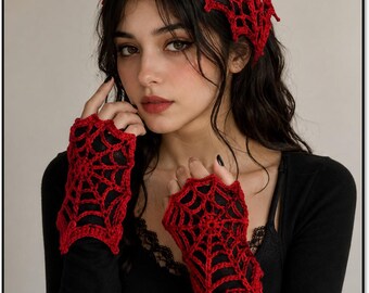 May include: A red crochet headscarf and matching fingerless gloves, both featuring an intricate spiderweb pattern. The headscarf is triangular in shape, and the gloves cover the back of the hands with a delicate, open-work web design.