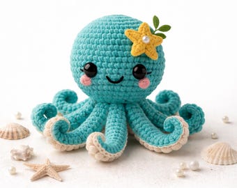 May include: A turquoise and cream crocheted octopus, decorated with a yellow starfish and green leaves. The octopus has a smiling face with black eyes and pink cheeks. Seashells and pearls are scattered around the octopus.