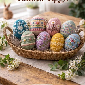 Puede incluir: Una cesta de mimbre contiene ocho huevos de Pascua hechos a mano con ganchillo. Los huevos son de varios colores, incluyendo azul, rosa, verde y amarillo, y presentan patrones florales y geométricos. El texto "Handmade Crochet Easter Eggs" está en la parte superior.