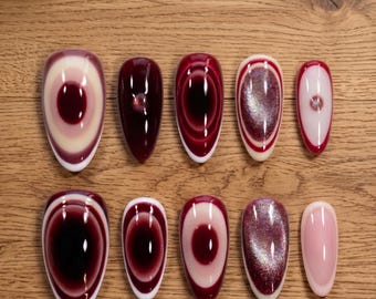 Uñas postizas estilo gótico burdeos, lujosas, con efecto de ilusión óptica 3D y brillo de vampiro.
