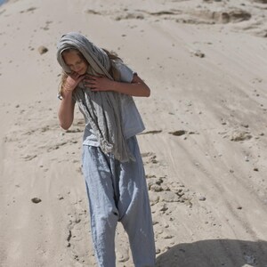 KnockKnockLinen “Silence” short-sleeve linen top—light grey, buttoned front, loose fit—shown on model outdoors with a long natural-flax linen scarf and relaxed linen pants against a sandy backdrop. Linen blouse / buttoned linen top.