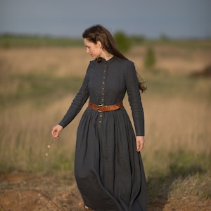 Girl with a Beautiful Victoria Linen Dress: A period dress with sleeves, Victorian charm, and convenient pockets. This boho maxi dress combines antique allure with modern style, made by KnockKnockLinen.