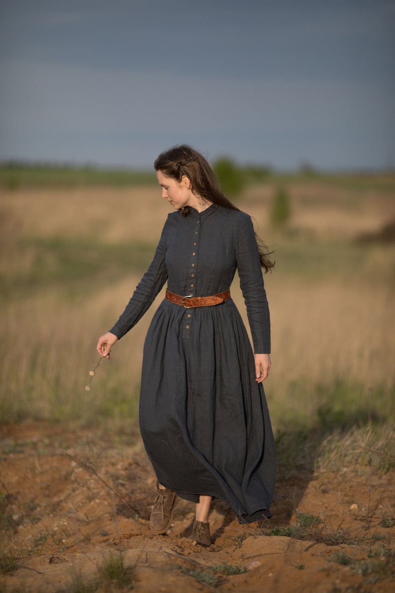 Girl with a Beautiful Victoria Linen Dress: A period dress with sleeves, Victorian charm, and convenient pockets. This boho maxi dress combines antique allure with modern style, made by KnockKnockLinen.