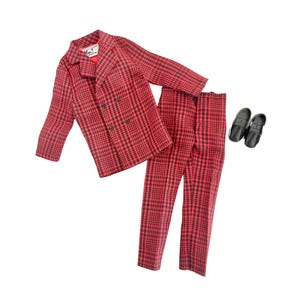 May include: A vintage red and black checked suit, comprising a double-breasted blazer, matching trousers, and black loafers. The blazer features a "Von Furstenberg" label. The suit is a classic style, suitable for various occasions.