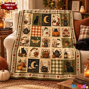 May include: A throw blanket featuring a grid of illustrations including ghosts, black cats, pumpkins, crescent moons, tea sets, and autumn foliage. The design incorporates checkered patterns and floral borders in shades of orange, green, and cream.
