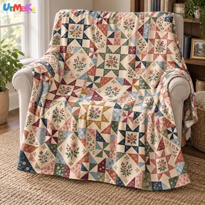 May include: A throw blanket featuring a patchwork quilt design with star patterns and floral motifs in shades of cream, blue, green, pink, and burgundy. The fabric displays repeating geometric shapes and botanical illustrations throughout.