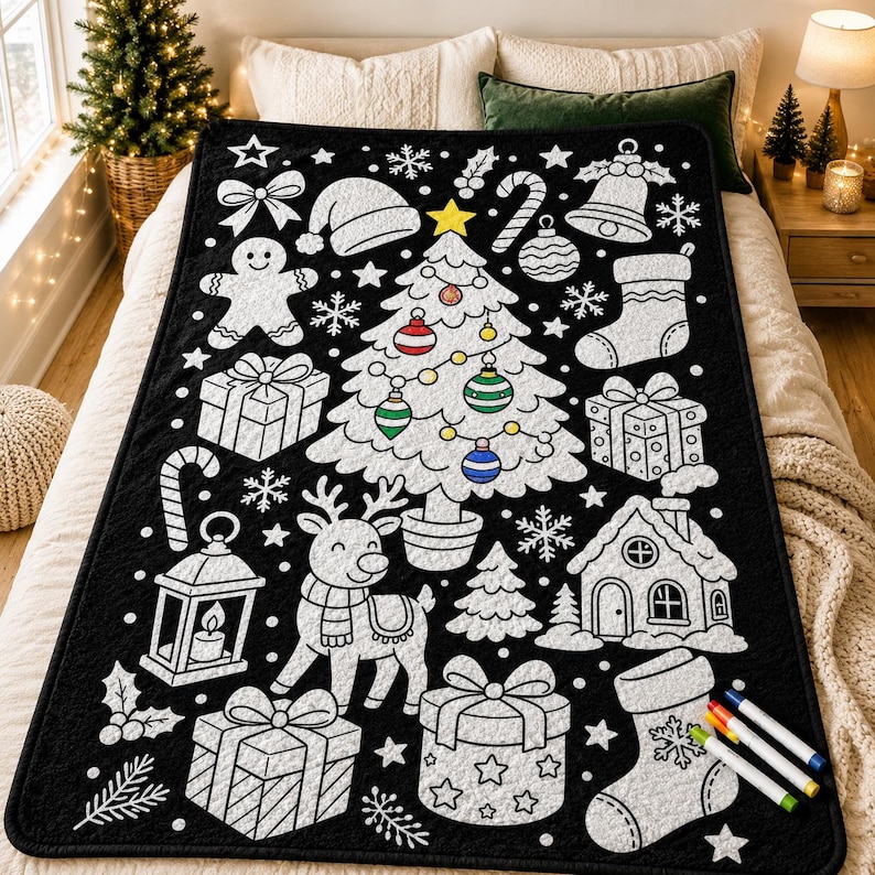 May include: A black throw blanket featuring a white outline pattern of Christmas icons including a central tree with colorful ornaments, a reindeer, gingerbread person, gifts, stockings, a lantern, and a house, accompanied by four markers.