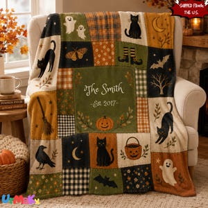 May include: A patchwork throw blanket featuring Halloween-themed illustrations including black cats, ghosts, bats, a jack-o'-lantern, a broom, and a crescent moon. The centre panel displays the text The Smith Est 2017 in a white script font.