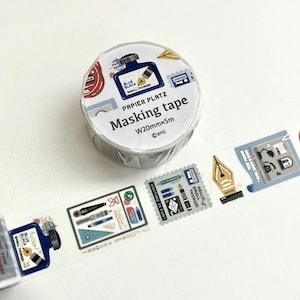 May include: A roll of masking tape with a white background. The tape is labeled "Masking tape" and features illustrations of ink bottles, pens, and stamps. The tape is 20mm wide and 5m long.