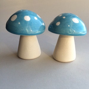 May include: Two blue ceramic mushroom salt and pepper shakers with white polka dots.