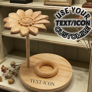 May include: A wooden sunflower-shaped display stand with a round base and a smaller ring. The sunflower is supported by a wooden pole. The base has the text "TEXT/ICON" engraved on it. The image also includes the text "USE YOUR TEXT/ICON CUSTOMIZE".